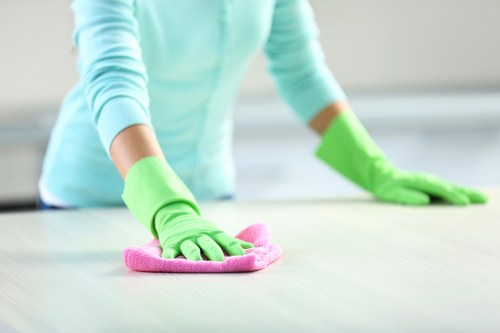 Worker using protective gloves during carpet cleaning